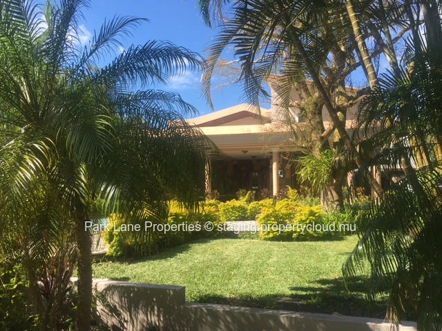 Double-storey home overlooking a magnificent pool and mature trees in Floreal