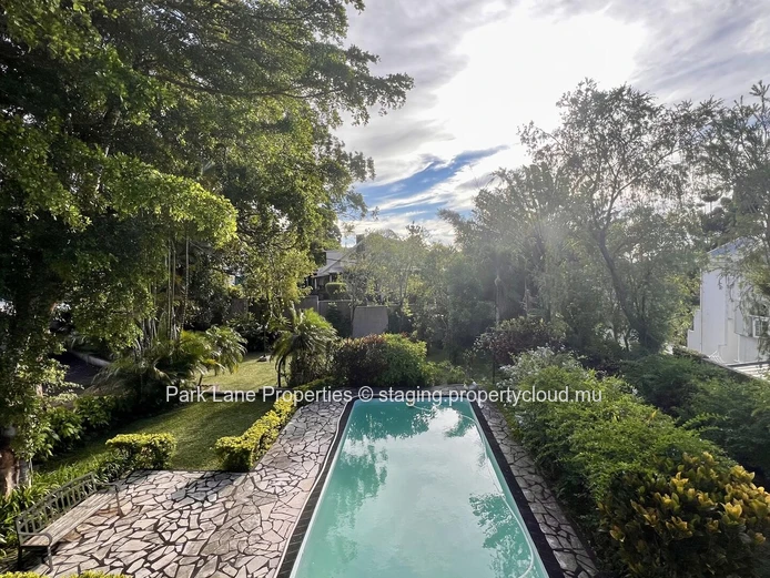 Double-storey home overlooking a magnificent pool and mature trees in Floreal